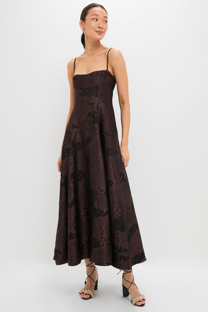 Young woman in Arabica Jacquard Theron Midi Dress, classic spaghetti-strap gown with lace pattern, paired with effortless, fun block-heeled sandals, showcasing high-end style.
