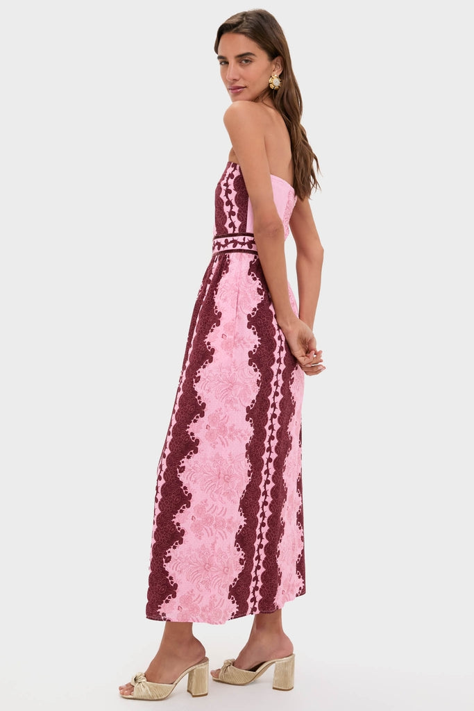 Model in profile wearing Blush and Maroon Abstract Bennet Midi Dress, showcasing its classic, high-end floral patterns and effortless style, paired with fun block-heel mules and a statement earring.