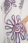Namur Celeste Amaranta Dress showcases a classic, high-end design with an effortless, fun abstract floral motif in dark purple and pale blue on off-white fabric.