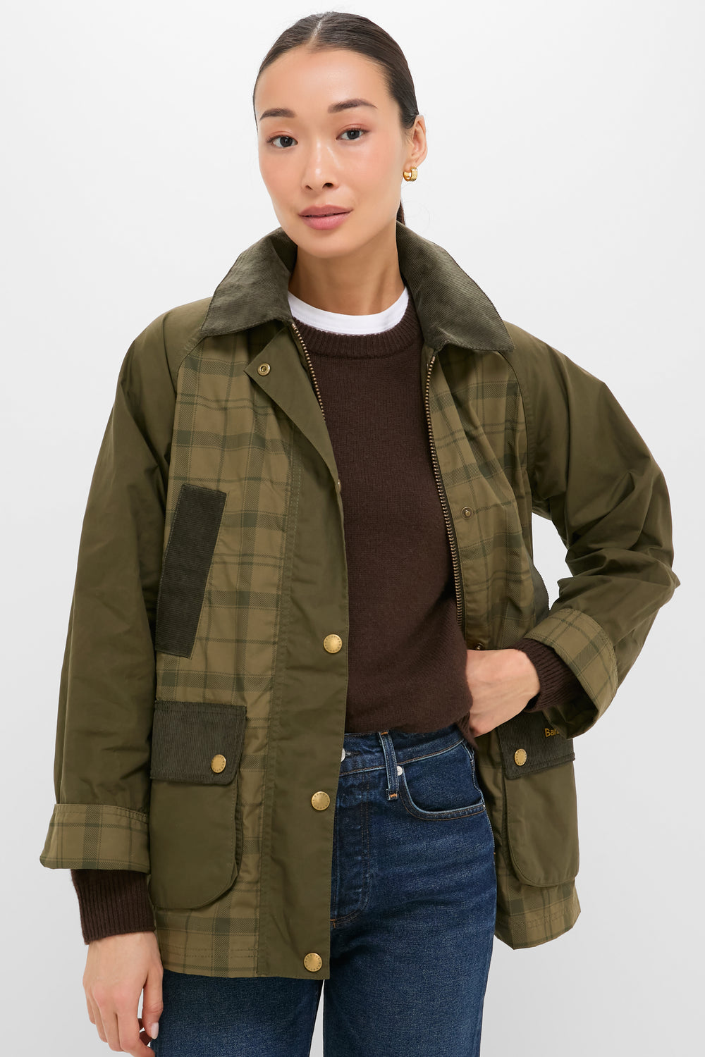 Model wearing Dusky Green Modern Tartan Beadnell Casual Jacket with corduroy collar, over dark sweater and jeans; a classic, effortless, and fun high-end countryside style.