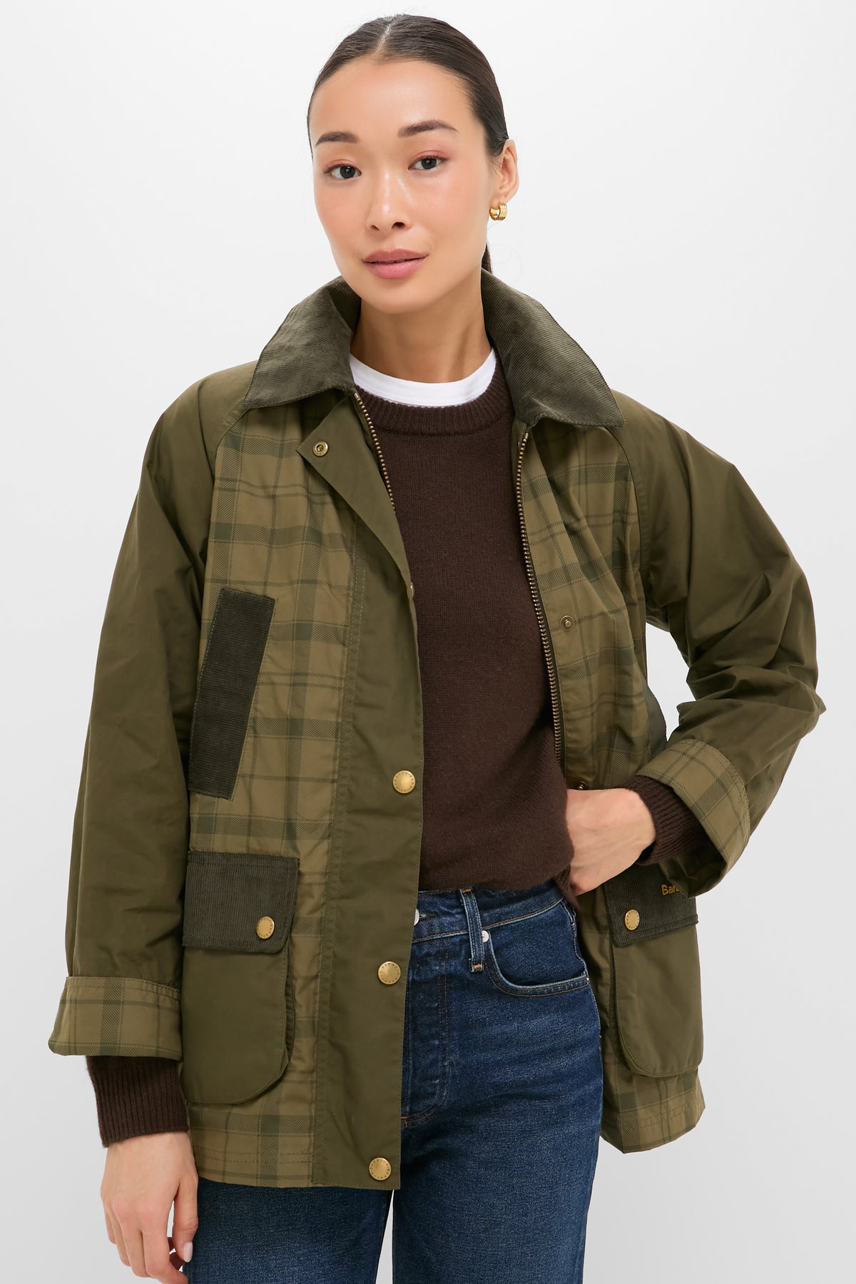 Model wearing Dusky Green Modern Tartan Beadnell Casual Jacket with corduroy collar, over dark sweater and jeans; a classic, effortless, and fun high-end countryside style.