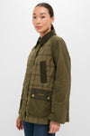 Model wearing the Dusky Green Modern Tartan Beadnell Casual Jacket, featuring a classic plaid pattern, corduroy details, and brass snaps, embodying effortless, high-end countryside style.