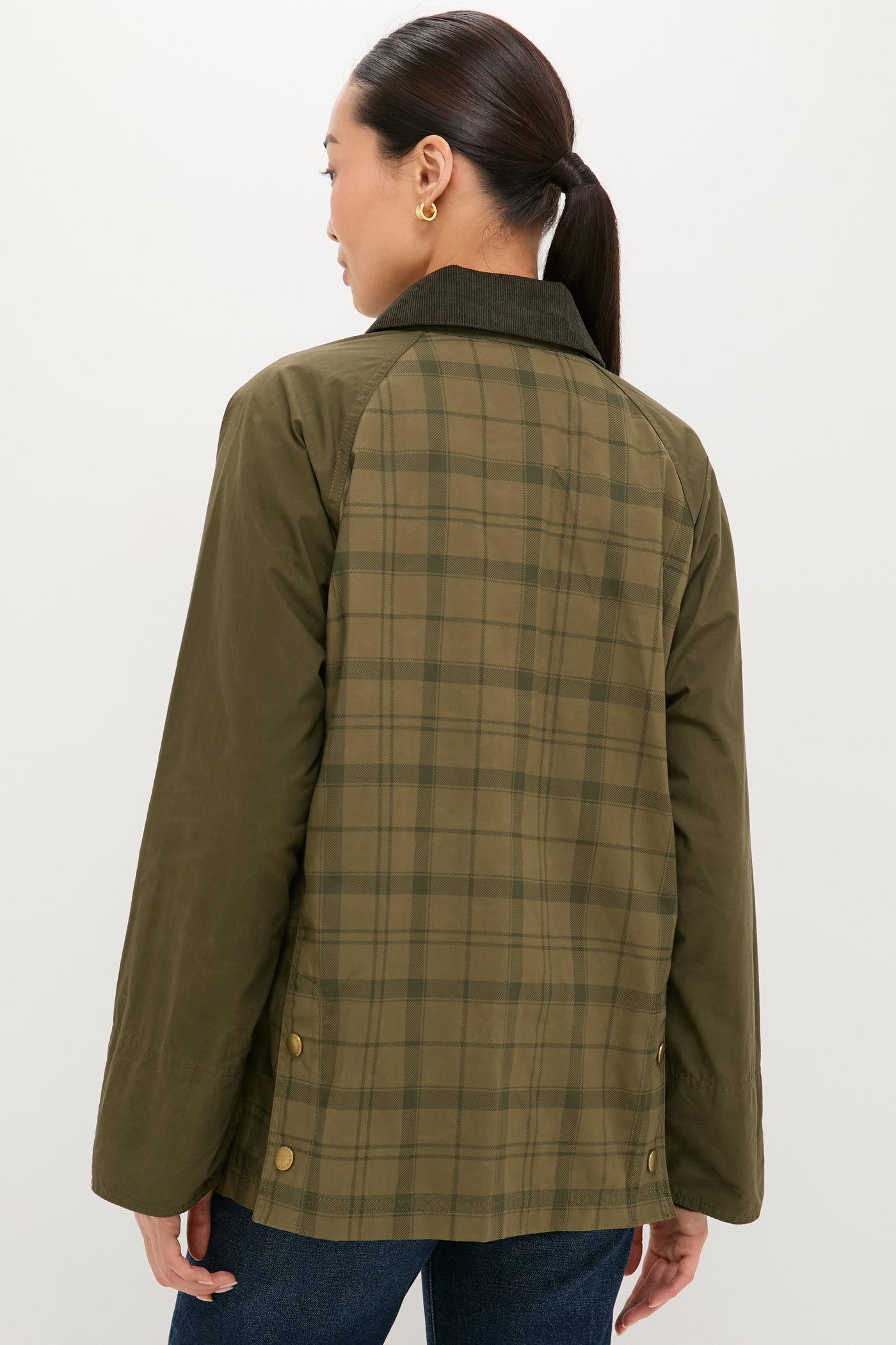 Person wearing Dusky Green Modern Tartan Beadnell Casual Jacket, featuring a classic plaid back, olive sleeves, corduroy collar, and brass snap details, embodying effortless, high-end style.