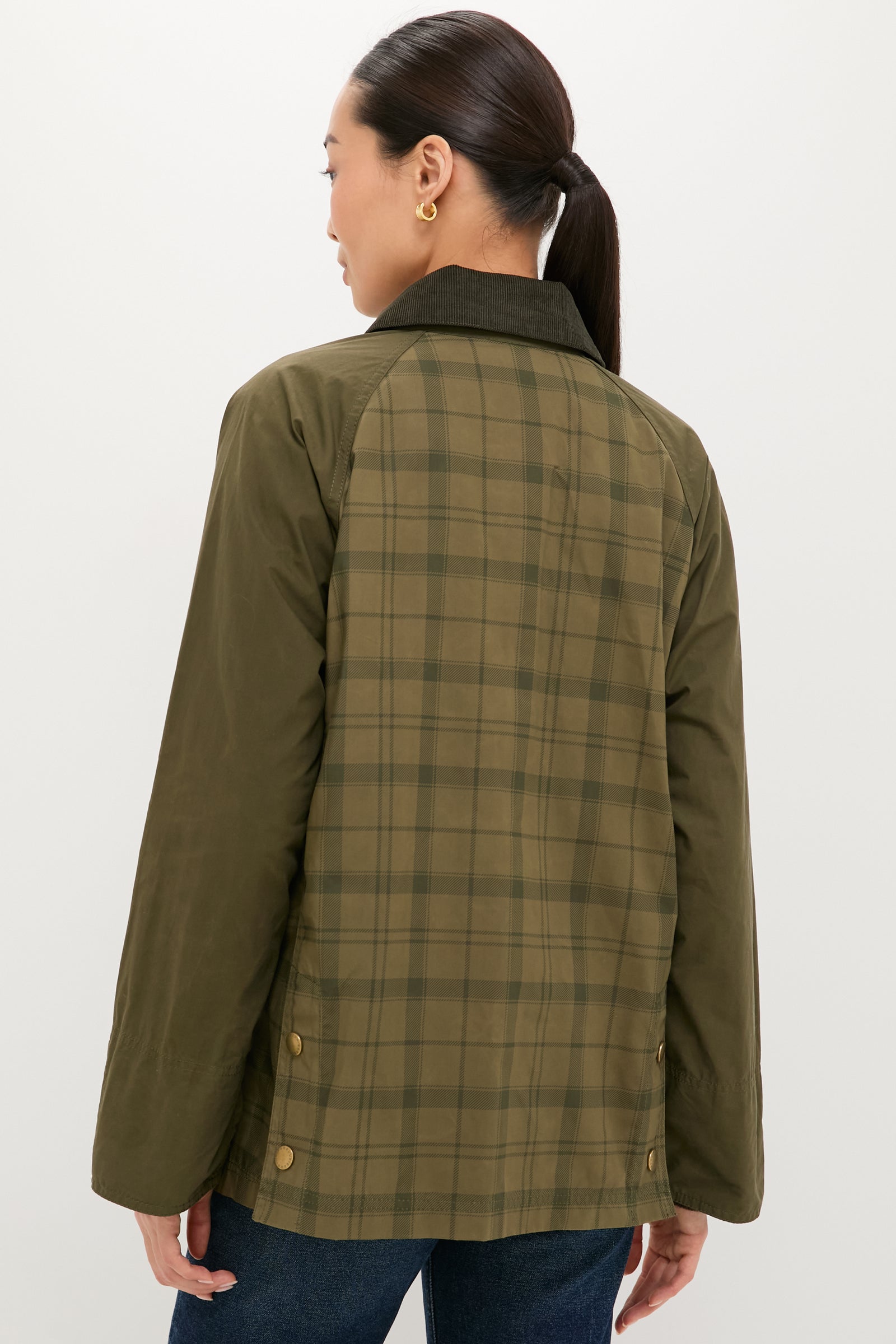 Person wearing Dusky Green Modern Tartan Beadnell Casual Jacket, featuring a classic plaid back, olive sleeves, corduroy collar, and brass snap details, embodying effortless, high-end style.