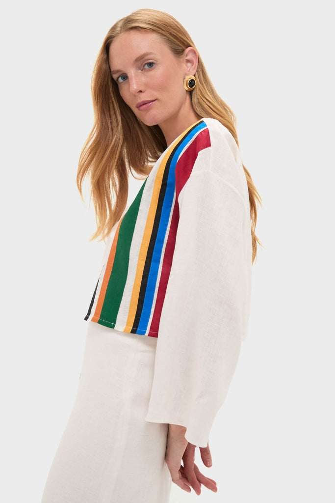 Model wearing the Roman Sassari Top, a classic and effortless ivory top with a bold, colorful stripe panel, paired with a light skirt, embodying high-end, fun style.