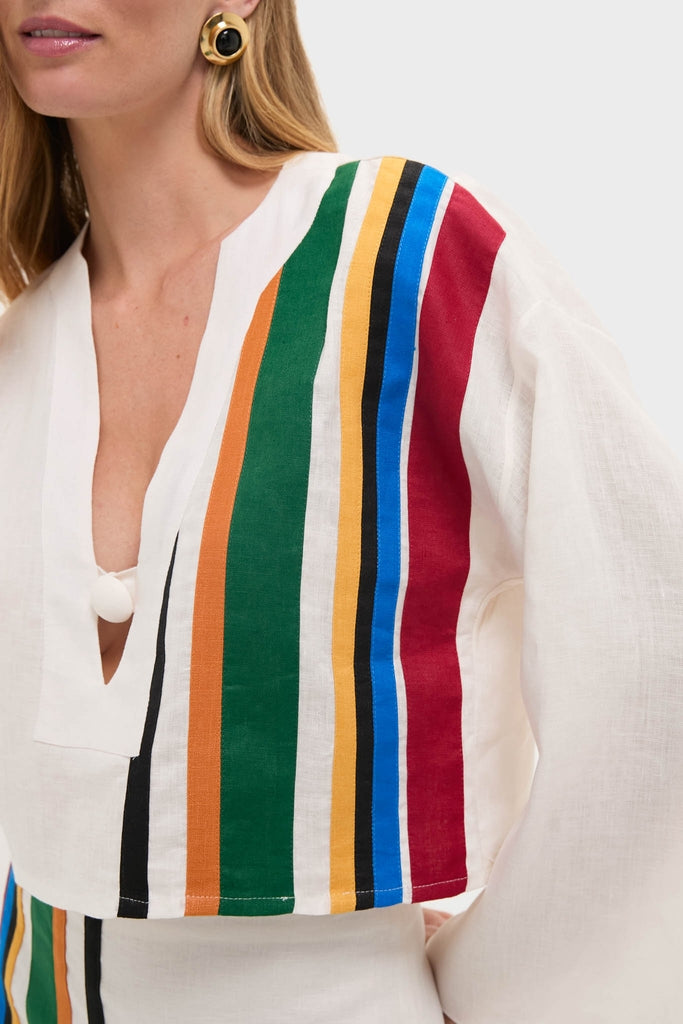 Woman modeling the Roman Sassari Top, a classic, lightweight linen piece with bold, vertical stripes. Effortless V-neck design, paired with matching bottom, exuding fun, high-end style.