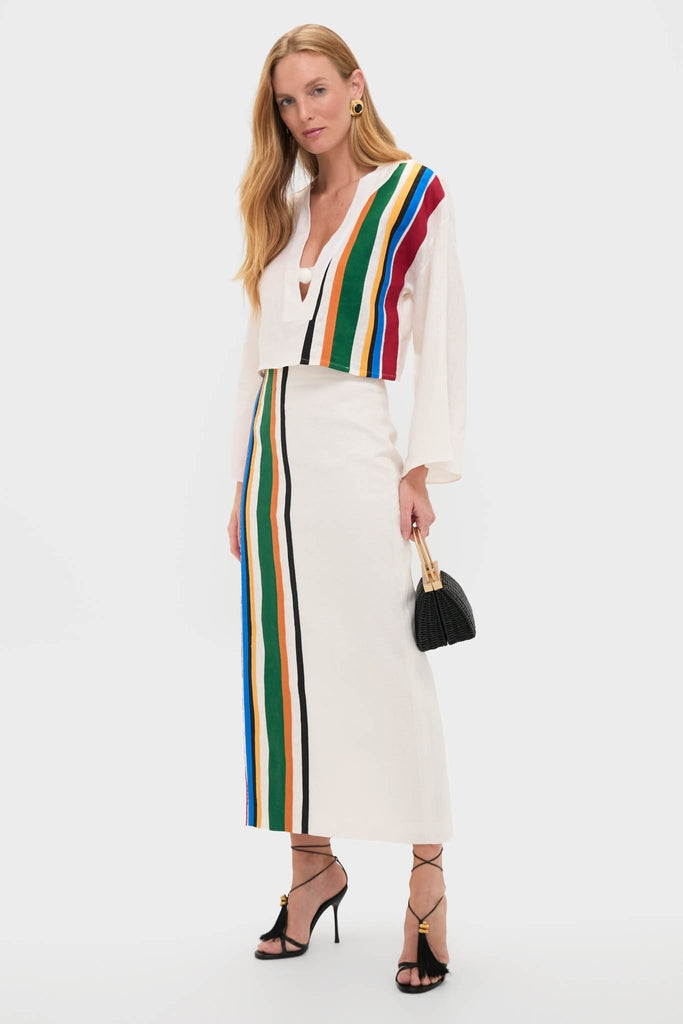 Tall woman models the Roman Lima Midi Skirt in a classic, high-end knit set with bold stripes, exuding effortless style. Paired with strappy sandals and a structured bag.