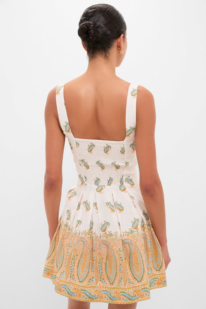 Cree Jardin Bodice Mini Dress: A classic, effortless, high-end linen dress with smocked bodice and A-line silhouette, showcasing a fun paisley motif, perfect for sun-drenched days.