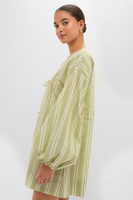 Woman in Faded Juniper Ombre Stripe Pia Mini Dress with classic balloon sleeves and an effortless tie-neck, embodying a fun, high-end style for a relaxed, chic look.
