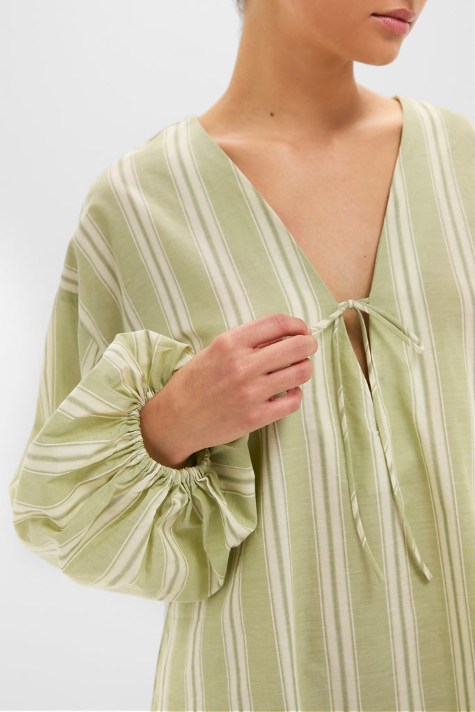 Faded Juniper Ombre Stripe Pia Mini Dress with classic V-neck, effortless self-tie, and fun, high-end billowy sleeves, embodying a relaxed, chic silhouette for versatile styling.