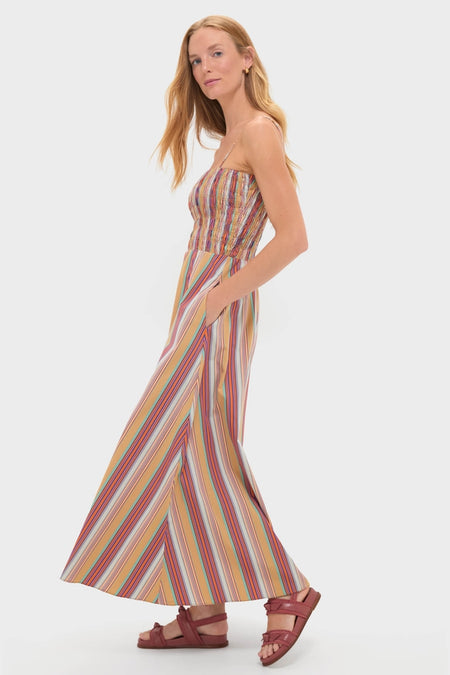 Young woman models the classic Mustard Agua Stripe Annikekn Maxi Dress, featuring an effortless smocked bodice and flowing A-line skirt, perfect for high-end, fun resort wear.