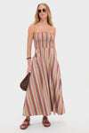 Woman models the classic Mustard Agua Stripe Annikekn Maxi Dress, featuring an effortless A-line silhouette with adjustable straps. She accessorizes with sunglasses, a woven handbag, and sandals.