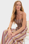 Young woman in classic, effortless Mustard Agua Stripe Annikekn Maxi Dress with shirred bodice, A-line silhouette, and adjustable straps, embodying high-end, fun style.