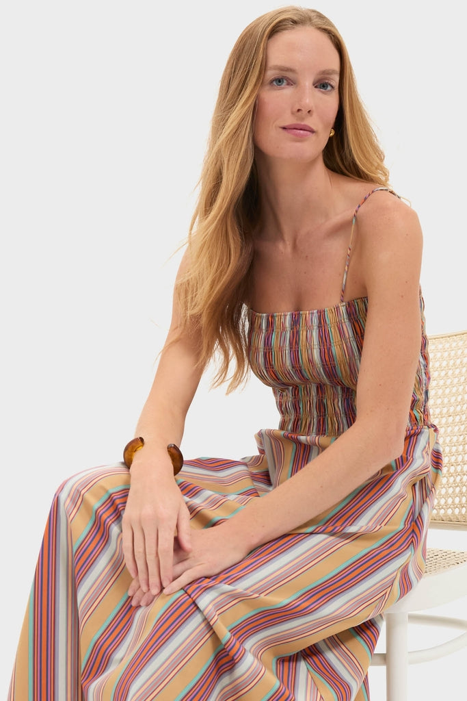 Young woman in classic, effortless Mustard Agua Stripe Annikekn Maxi Dress with shirred bodice, A-line silhouette, and adjustable straps, embodying high-end, fun style.
