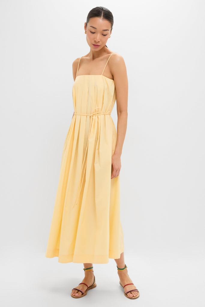 Woman models the Banana Lopez Midi Dress, a classic, effortless A-line sundress with adjustable straps and removable tie, paired with fun, high-end strappy sandals.