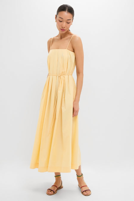 Woman models the Banana Lopez Midi Dress, a classic, effortless A-line sundress with adjustable straps and removable tie, paired with fun, high-end strappy sandals.