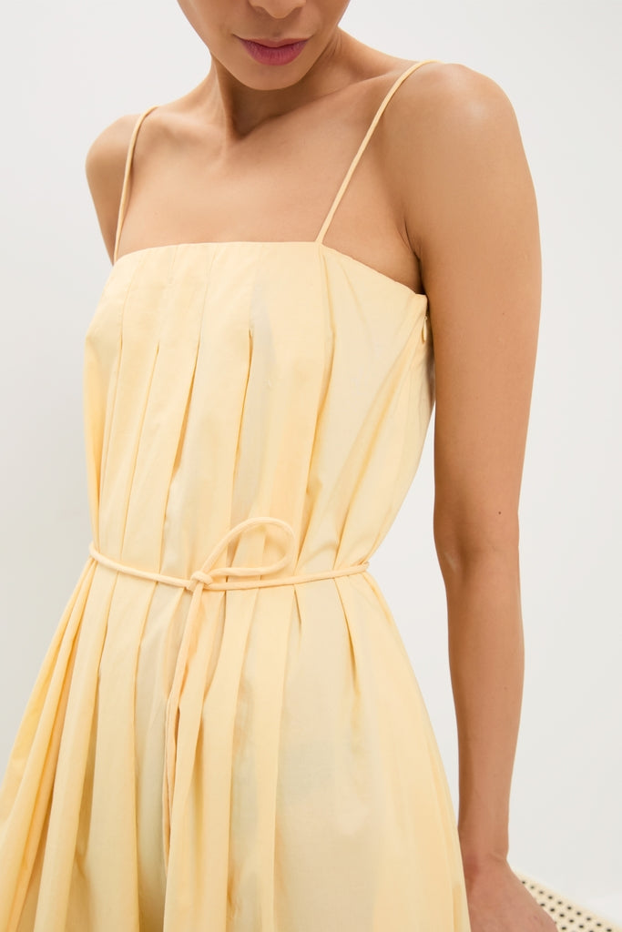 Banana Lopez Midi Dress: Classic, effortless A-line silhouette with box pleats and thin straps, cinched with a removable tie for a fun, high-end look.