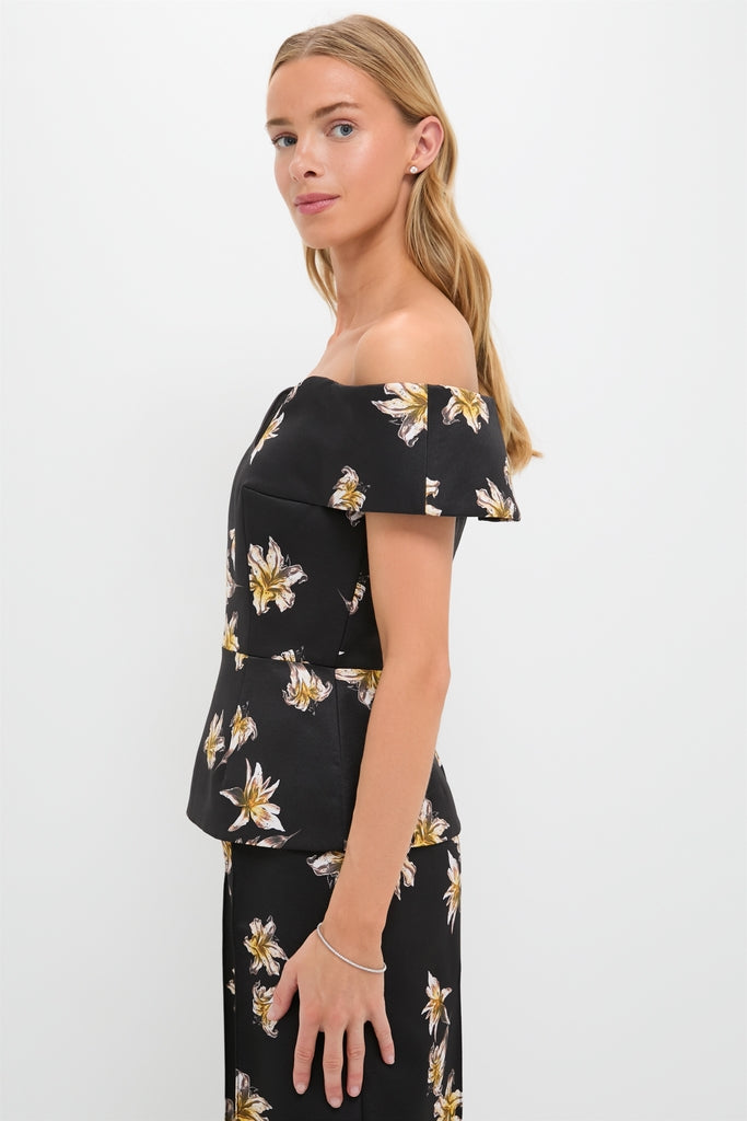 Model wearing the classic Black and Yellow Souline Top, an effortlessly chic off-the-shoulder piece with a peplum design, paired with a matching skirt.