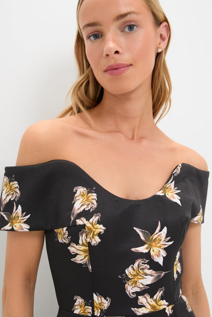Young woman in a classic, high-end Black and Yellow Souline Top with off-the-shoulder design, adorned with lilies, capturing an effortlessly cool and fun style.
