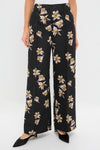 Black and Yellow Daffy Trousers featuring a classic wide-leg design with high waist and front seam detailing, adorned with cream and yellow lilies for an effortless, high-end look.