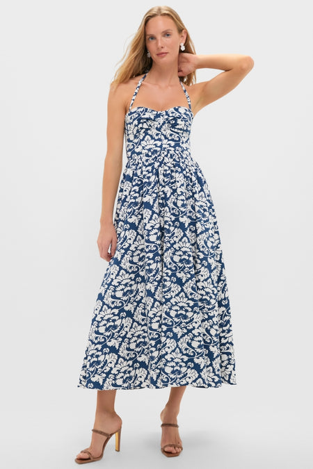 Young woman in a classic, effortless Dark Blue Johanna Midi Dress with a sweetheart neckline and full A-line skirt, paired with fun, high-end brown heeled sandals.