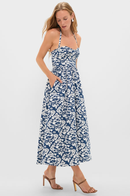 Woman modeling the classic Dark Blue Johanna Midi Dress with a sweetheart neckline and full skirt, showcasing an effortless, fun, and high-end style.