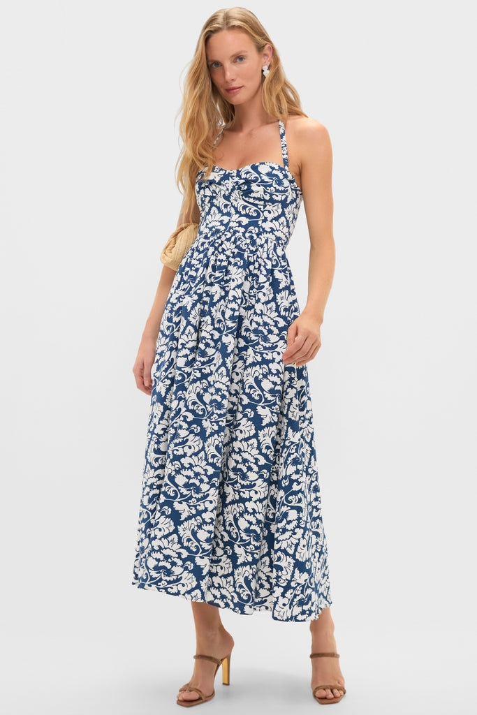 Young woman models the classic Dark Blue Johanna Midi Dress with a romantic floral print, featuring an effortless sweetheart neckline and fun, flowing skirt.