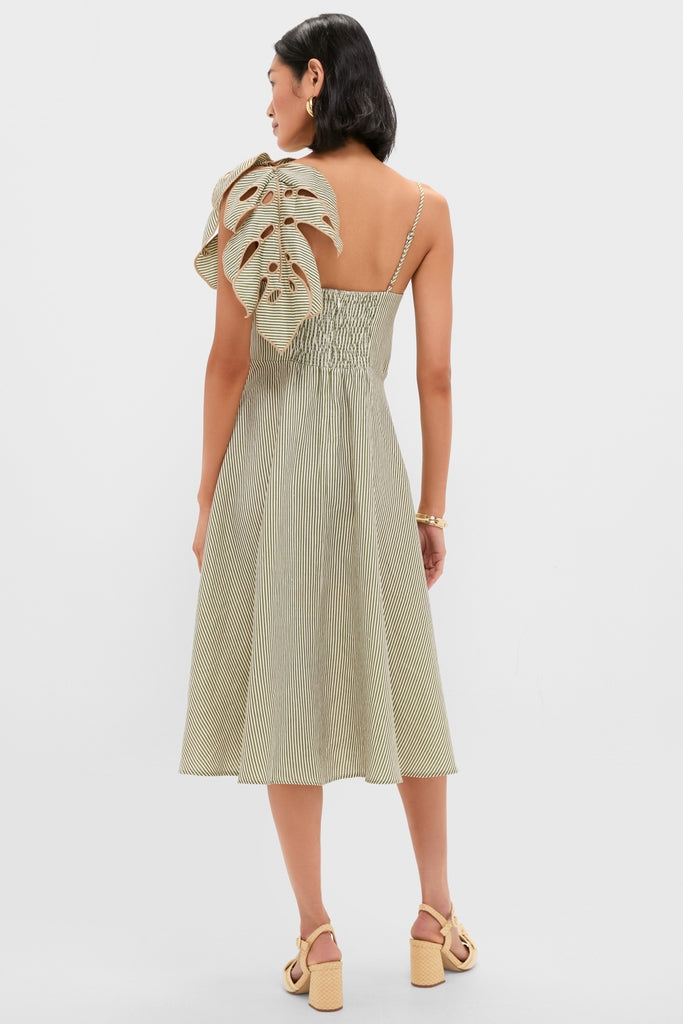 Woman in a Green Striped Monsterea Leaf Sleeveless Midi Dress, showcasing an asymmetric ruffle detail and spaghetti strap, paired with matching block-heel sandals for an effortless, high-end look.