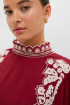 Young woman in a classic, high-end Burgundy Bicolor Palm Tree Embroidery Blouse with white detailing, exuding effortless style and fun sophistication, perfect for confident, everyday elegance.