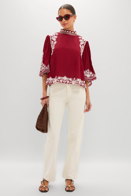 Model wearing the Burgundy Bicolor Palm Tree Embroidery Blouse, effortlessly styled with cream trousers and chic accessories for a classic, high-end look.