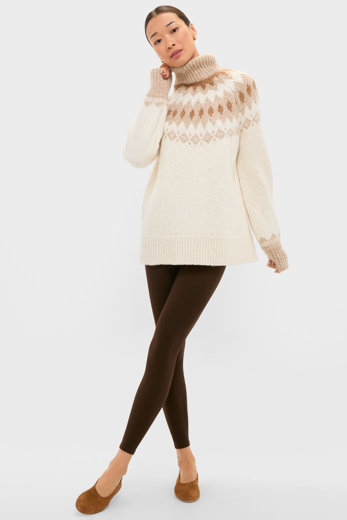 Ivory Camel Estelle Fair Isle Turtleneck exudes classic, effortless style. Paired with dark leggings, it offers a fun, high-end look, perfect for versatile, cozy outings.