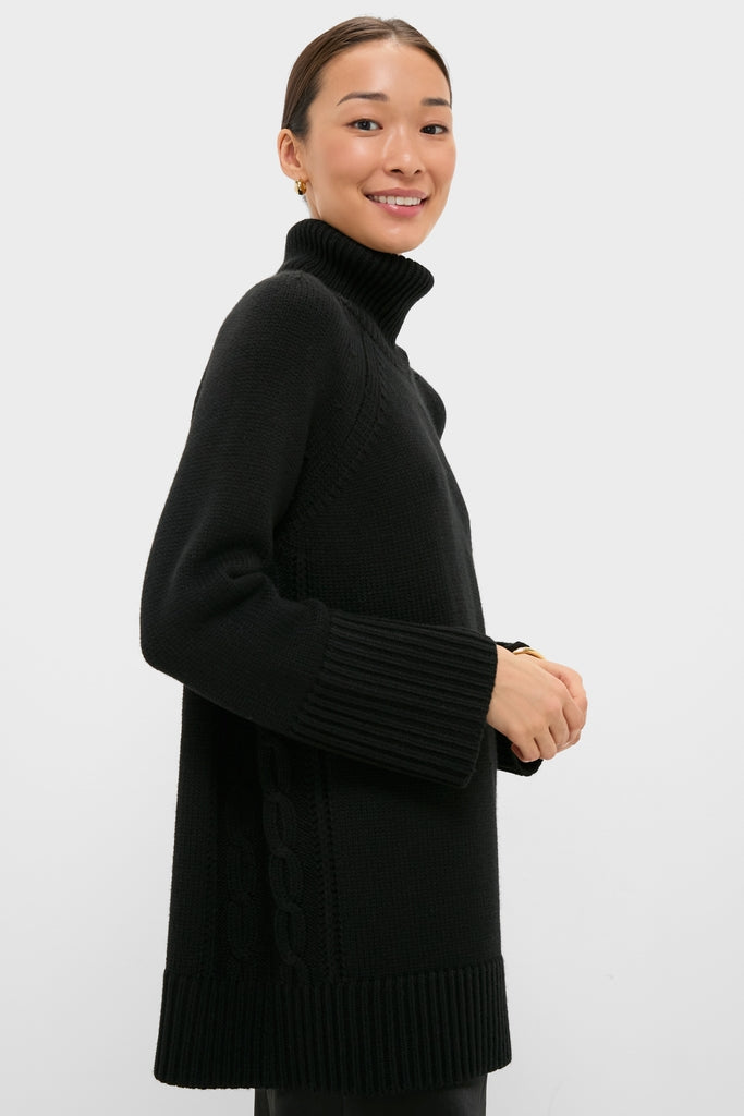 Young woman wearing classic Black Louisa Turtleneck Sweater with high-end cable-knit detailing, ribbed cuffs, and foldover neck, embodying effortless, fun sophistication.