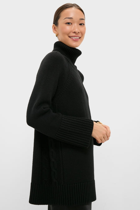 Young woman wearing classic Black Louisa Turtleneck Sweater with high-end cable-knit detailing, ribbed cuffs, and foldover neck, embodying effortless, fun sophistication.