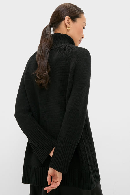 Model wearing the classic Black Louisa Turtleneck Sweater with a fold-over neck and ribbed cuffs, exuding effortless, high-end style against a simple backdrop.