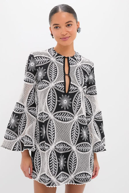 Young woman wearing the classic Black Plain Gia Mini Dress with an effortless lace-inspired pattern and keyhole neckline, exuding a high-end, fun, confident style.