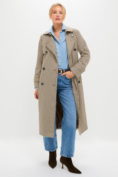 Woman models a classic Brown Plaid Long Trench Coat, exuding an effortless and high-end style, paired with denim shirt and jeans, creating a fun, confident look.