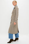 Woman models a classic Brown Plaid Long Trench Coat, featuring a belted waist and small check pattern, paired with light jeans and high-end suede ankle boots for an effortless, fun look.