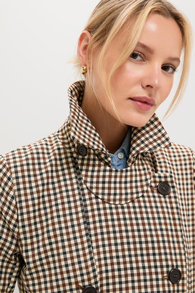 Close-up of a woman wearing a classic Brown Plaid Long Trench Coat with a high-collared, double-breasted design, exuding effortless and high-end style.