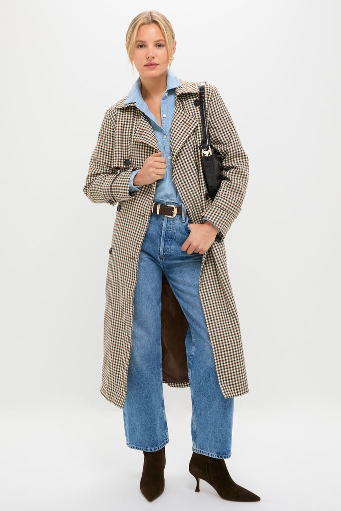 Woman models a classic, high-end Brown Plaid Long Trench Coat, exuding effortless style, layered over a denim shirt and jeans, embodying a fun, confident fall look.