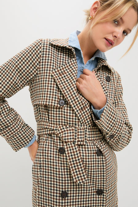 Classic and high-end, the Brown Plaid Long Trench Coat features a double-breasted design and belt, effortlessly paired with a light blue chambray shirt for a fun, confident look.