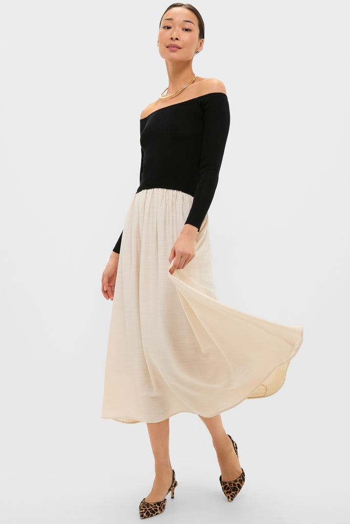 Model in a classic, high-end Black and Ivory Off Shoulder Maxi Dress with leopard-print heels, showcasing an effortless, fun style with a fitted bodice and A-line skirt.