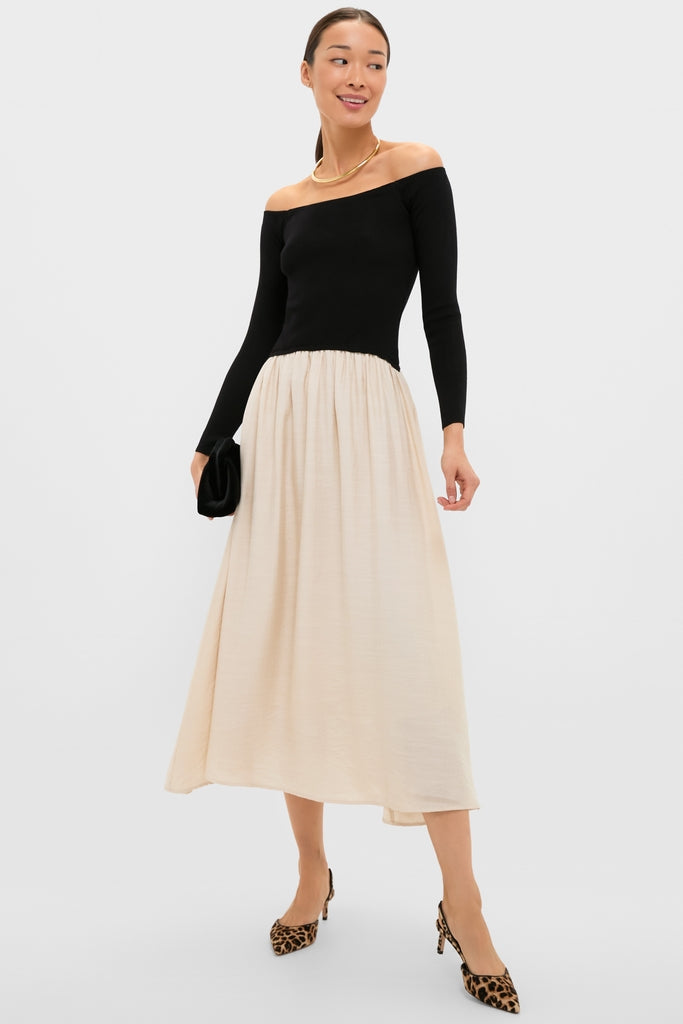 Classic Black and Ivory Off Shoulder Maxi Dress, featuring an off-the-shoulder fitted bodice and A-line skirt, styled with leopard-print heels for an effortless, high-end look.