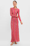 Model wearing the Electric Wave Pink Scarlet Maxi Dress, a classic, effortless knit dress with a multicolored chevron pattern, styled with gold accessories for a fun, high-end look.