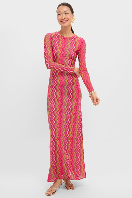 Model wearing the Electric Wave Pink Scarlet Maxi Dress, a classic, effortless knit dress with a multicolored chevron pattern, styled with gold accessories for a fun, high-end look.