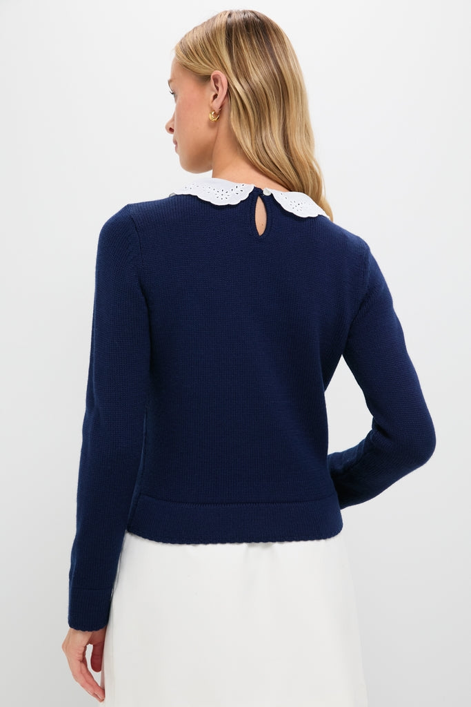 Woman in a Navy Violette Sweater with a white scalloped eyelet collar, showcasing a classic, effortless, and high-end style. Perfectly combines fun and modern sophistication.