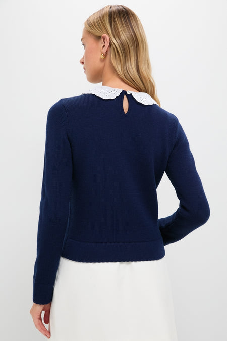 Woman in a Navy Violette Sweater with a white scalloped eyelet collar, showcasing a classic, effortless, and high-end style. Perfectly combines fun and modern sophistication.