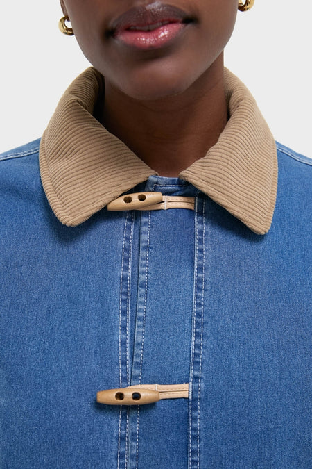 Indigo Barn Jacket with tan corduroy collar and wooden toggle fastenings, embodying a classic, effortless style. Ideal for a high-end, fun look.