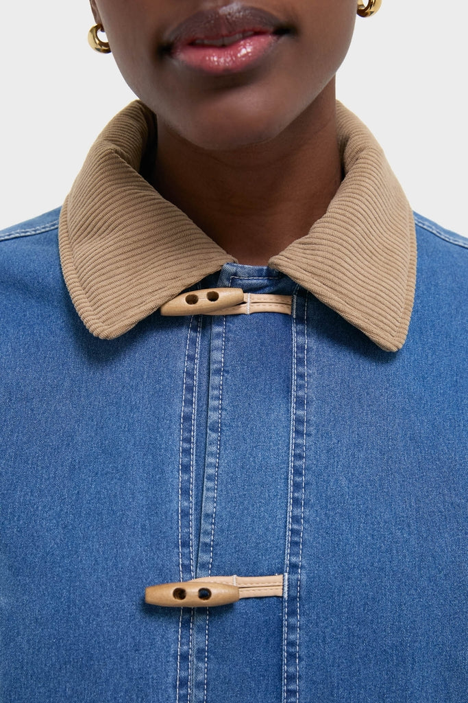 Indigo Barn Jacket with tan corduroy collar and wooden toggle fastenings, embodying a classic, effortless style. Ideal for a high-end, fun look.