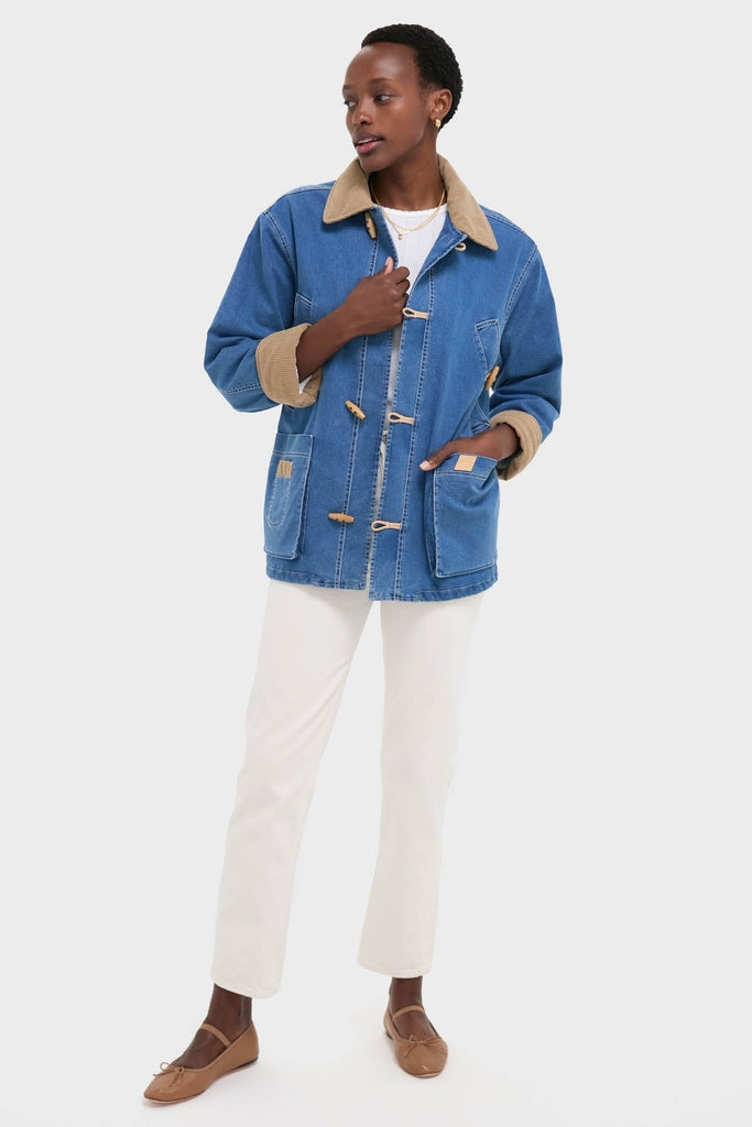 Woman wearing the Indigo Barn Jacket with a sherpa collar and toggle fastenings, styled with classic ivory jeans and effortless tan flats for a high-end, fun look.
