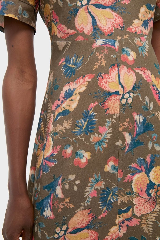 Model wearing the Olive Floral Casey Dress, showcasing its classic, effortless design with a bright tropical floral print and a center seam, embodying a fun, high-end style.